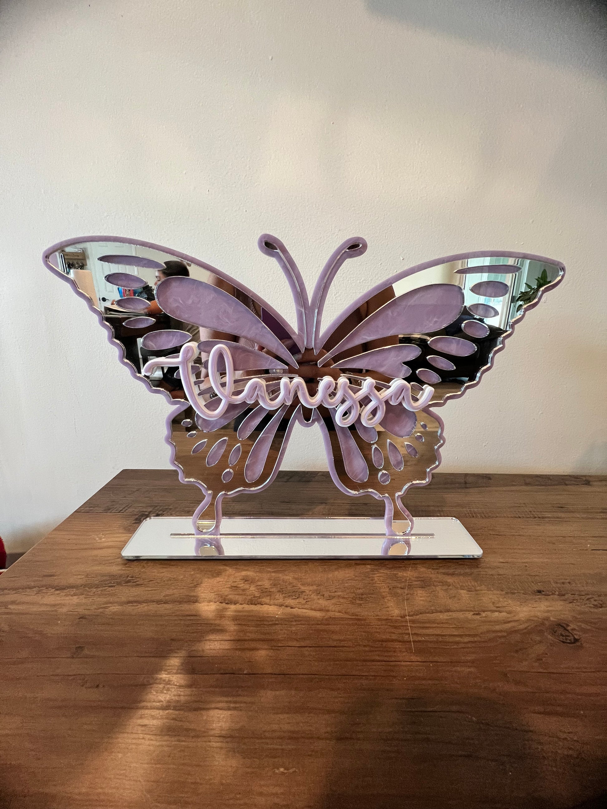 Name over butterfly with stand